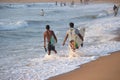 Kovalam, Chennai, Tamilnadu, India - Ã¢â¬Å½Ã¢â¬Å½August 9th Ã¢â¬Å½2021: Two young Indian surfers carrying surfboard and walking on the